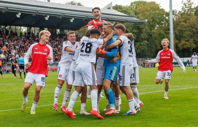 22.08.2026 - Fussball - Saison 2026 2027 - DFB Pokal Vereinspokal - 01. Runde: Viktoria Köln - 1. FC Nürnberg Nuernberg FCN ( Club ) - Sportfoto Zink DaMa - xdaxmax - regulations prohibit any use of photographs as image sequences and or quasi-video - Jubel Freude nach Spielende - Jan Reichert (1, 1. FC Nürnberg FCN ) und Mannschaft Team jubelt Jubel nach gehaltenen Elfmeter im Elfmeterschießen - nach Sieg des FCN *** August 22, 2026 Soccer Season 2026–2027 DFB Cup Club Cup First Round Viktoria Cologne 1 FC Nuremberg Nuremberg FCN Club Sports Photo Zink DaMa xdaxmax regulations prohibit any use of photographs as image sequences and or quasi-video celebrationsJubilation and joy after the final whistle Jan Reichert 1, 1 FC Nuremberg (FCN) and the team celebrate after saving a penalty kick in the penalty shootout following FCN’s victory