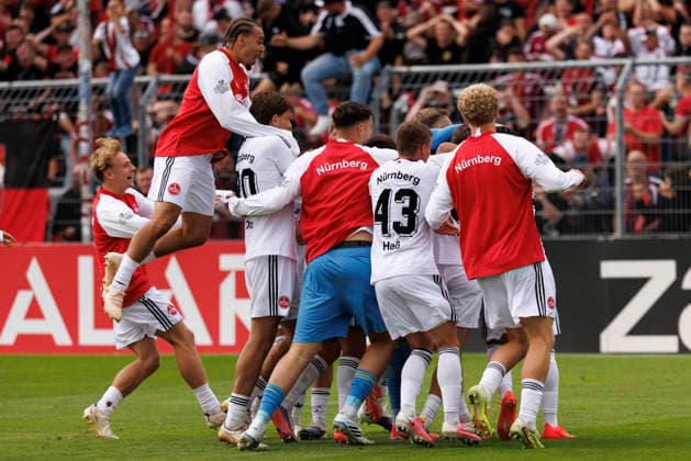 KOELN, GERMANY - AUGUST 22, 2026: Jan Reichert (1. FC Nuernberg, 1) celebrates with teammates after the penalty shootout during the DFB-Cup match between Viktoria Koeln vs. 1. FC Nuernberg at the Sportpark Hoehenberg on August 22, 2026 in Koeln, Germany. DFL REGULATIONS PROHIBIT ANY USE OF PHOTOGRAPHS AS IMAGE SEQUENCES AND OR QUASI-VIDEO. Nordrhein-Westfalen Germany Copyright: xAxelxKohringx
