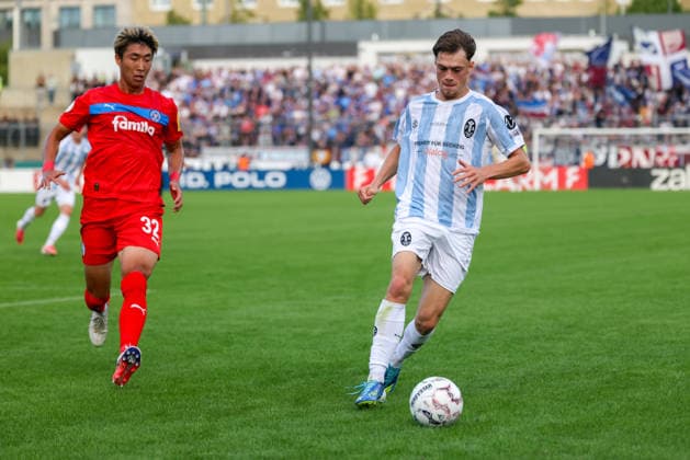 Emre Erdogan (TSV 1860 Muenchen, 19) mit Hiroki Sekine (Holstein Kiel, 32), GER, TSV 1860 Muenchen vs. Holstein Kiel, Fussball, DFB-Pokal, 1. Runde, Saison 2026 2027, 22.08.2026, DFL REGULATIONS PROHIBIT ANY USE OF PHOTOGRAPHS AS IMAGE SEQUENCES, GER, TSV 1860 Muenchen vs. Holstein Kiel, Fussball, DFB-Pokal, 1. Runde, Saison 2026 2027, 22.08.2026 Muenchen *** Emre Erdogan, TSV 1860 Munich, 19, with Hiroki Sekine, Holstein Kiel, 32, GER, TSV 1860 Munich vs. Holstein Kiel, Soccer, DFB Cup, 1st Round, 2026–2027 Season, August 22, 2026, DFL regulations prohibit any use of photographs as image sequences, GER, TSV 1860 Munich vs. Holstein Kiel, soccer, DFB Cup, 1st round, 2026–2027 season, August 22, 2026, Munich Copyright: xEibner-Pressefoto JennixMaulx EP_JML