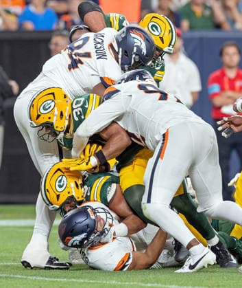 August 22, 2026, Denver, Colorado, USA: Broncos Defense swarms the Packers RB CHRIS BROOKS during the 2nd. Half at Empower Field at Mile High Friday evening. Packers beat the Broncos in Pre-Season 33-13. Credit Image: ZUMA Press Wire) Denver USA - ZUMAav4_ 20260822_zaf_av4_013 Copyright: xHectorxAcevedox