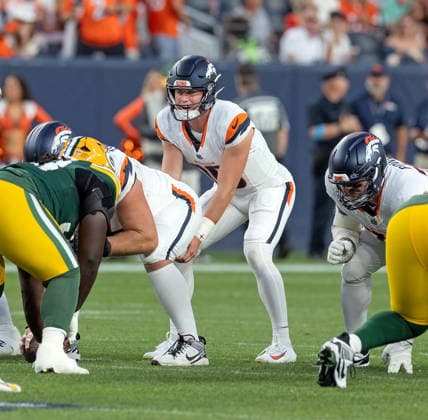August 22, 2026, Denver, Colorado, USA: Broncos QB BO NIX readies for the snap from center during the 1st. Half at Empower Field at Mile High Friday evening. Packers beat the Broncos in Pre-Season 33-13. Credit Image: ZUMA Press Wire) Denver USA - ZUMAav4_ 20260822_zaf_av4_032 Copyright: xHectorxAcevedox