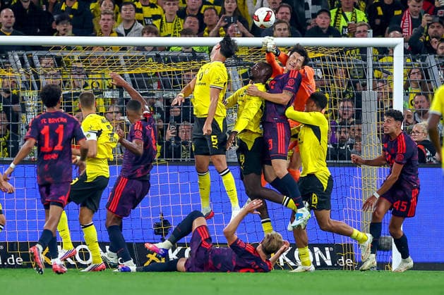 22.08.2026, Fußball, Borussia Dortmund - FC Bayern München, Signal Iduna Park, Saison 2026 2027: Torwart Manuel Neuer (FC Bayern München 01) verteidigt das Tor zusammen mit Min-jae Kim (FC Bayern München 03) Strafraumaktion gegen Ramy Bensebaini (BVB 05) Serhou Guirassy (BVB 09) Felix Nmecha (BVB 08) DFB regulations prohibit any use of photographs as image sequences and or quasi-video. Nordrhein-Westfalen Deutschland *** August 22, 2026, Soccer, Borussia Dortmund vs. FC Bayern Munich, Signal Iduna Park, 2026–2027 Season: Goalkeeper Manuel Neuer (FC Bayern Munich 01) defends the goal alongside Min Jae Kim (FC Bayern Munich 03) during a penalty area play against Ramy Bensebaini (BVB 05), Serhou Guirassy (BVB 09), and Felix Nmecha (BVB 08). DFB regulations prohibit any use of photographs as image sequences and or quasi-video. North Rhine-Westphalia, Germany