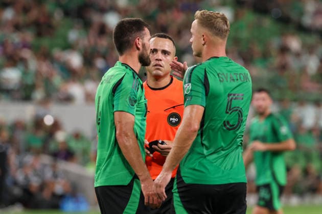 AUSTIN, TX - AUGUST 22: The referee checks on defender Brendan Hines-Ike 4 of the Austin FC after he goes hard to the pitch as defender Oleksandr Svatok 5 of the Austin FC listens in during the MLS, Fussball Herren, USA match between Austin FC and Philadelphia Union on August 22, 2026, at Q2 Stadium in Austin, TX. (Photo by David Buono Icon Sportswire) SOCCER: AUG 22 MLS Austin FC vs Philadelphia Union EDITORIAL USE ONLY Icon260822014