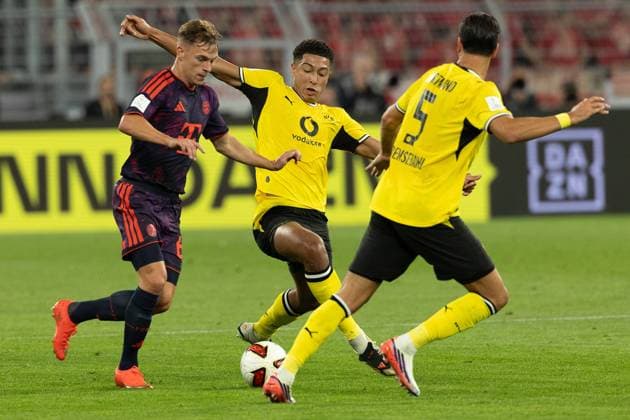 (260823) -- DORTMUND, Aug. 23, 2026 -- Jobe Bellingham (C) and Ramy Bensebaini (R) of Borussia Dortmund vie with Joshua Kimmich of FC Bayern Munich during the Franz Beckenbauer Supercup 2026 football match between FC Bayern Munich and Borussia Dortmund in Dortmund, Germany, Aug. 22, 2026. (Photo by Xinhua) (SP)GERMANY-DORTMUND-FOOTBALL-SUPERCUP-MUNICH VS DORTMUND JoachimxBywaletz 
