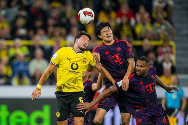 22.08.2026 - Fußball, 2026 2027, Franz-Beckenbauer-Supercup, Borussia Dortmund - FC Bayern München: (L-R) Rami Bensebaini (Dortmund), Min-jae Kim (München), Jonathan Tah (München) DFB REGULATIONS PROHIBIT ANY USE OF PHOTOGRAPHS AS IMAGE SEQUENCES AND OR QUASI-VIDEO. *** August 22, 2026 Soccer, 2026–2027, Franz Beckenbauer Super Cup, Borussia Dortmund vs. FC Bayern Munich, L R Rami Bensebaini (Dortmund), Min Jae Kim (Munich), Jonathan Tah (Munich). DFB regulations prohibit any use of photographs as image sequences and or quasi-video.