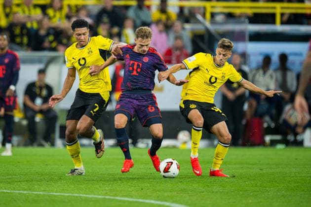 22.08.2026 - Fußball, 2026 2027, Franz-Beckenbauer-Supercup, Borussia Dortmund - FC Bayern München: (L-R) Jobe Bellingham (Dortmund), Joshua Kimmich (München), Giannis Konstantelias (Dortmund) DFB REGULATIONS PROHIBIT ANY USE OF PHOTOGRAPHS AS IMAGE SEQUENCES AND OR QUASI-VIDEO. *** August 22, 2026 Soccer, 2026–2027, Franz Beckenbauer Super Cup, Borussia Dortmund vs. FC Bayern Munich: L R Jobe Bellingham (Dortmund), Joshua Kimmich (Munich), Giannis Konstantelias (Dortmund). DFB regulations prohibit any use of photographs as image sequences and or quasi-video.