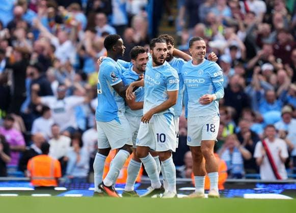 Manchester City players mob goalscorer Josko Gvardiol after VAR had awarded the winning goal Manchester City v Bournemouth, Premier League, Football, Etihad Stadium, Manchester, UK - 23 Aug 2026Manchester Etihad Stadium United Kingdom EDITORIAL USE ONLY No use with unauthorised audio, video, data, fixture lists, club league logos or live services. Online in-match use limited to 120 images, no video emulation. No use in betting, games or single club league player publications.  Copyright: xWiredxPhotos Shutterstockx 17113667by