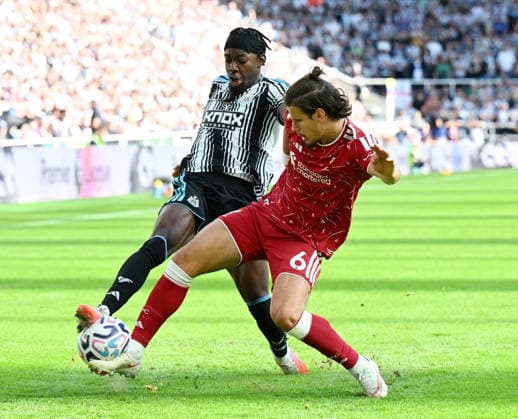 Newcastle Upon Tyne, England, 23rd August 2026. Anthony Elanga of Newcastle United tackled by Milos Kerkez of Liverpool during the Newcastle United vs Liverpool Premier League match at St. James Park, Newcastle Upon Tyne. Picture credit should read: Anna Gowthorpe Sportimage EDITORIAL USE ONLY. No use with unauthorised audio, video, data, fixture lists, club league logos or live services. Online in-match use limited to 120 images, no video emulation. No use in betting, games or single club league player publications. SPI_029_AG_Newcastle_Liverpool SPI-4932-0029