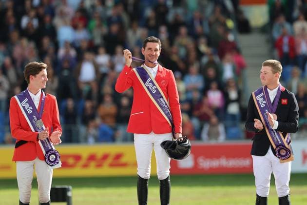 Siegerehrung, Jubel, 1. Platz, Weltmeister Steve Guerdat (SUI, Schweiz) mit Pferd Dynamix de Belheme, 2. Platz Thibeau Spits (BEL, Belgien, Belgium) mit Pferd Impress-K vaunt Kattenheye Z , Harry Charles (GBR, Vereinigtes Königsreich, Großbritannien) mit Pferd LT Holst Freda, Springen, FEI Jumping World Championship, WM, Weltmeisterschaft , FEI Jumping World Championship, Competition Individual Final, Longines-Prize, Longines-Preis, Finale Einzelwertung, Jumping , AACHEN - FEI World Championships 2026, Weltfest des Pferdesports, Reitsport Weltmeisterschaft 2026, Aachen 2026, Welcome Home 2026, Aachener Soers, 11. bis 23. August 2026, Reitsport, 23.08.2026, Aachen Aachener Soers Deutschland *** Awards Ceremony, Celebrations, 1st place: World Champion Steve Guerdat (SUI), Switzerland, riding Dynamix de Belheme; 2nd place: Thibeau Spits (BEL), Belgium, riding Impress K vaunt Kattenheye Z; Harry Charles (GBR), United Kingdom, riding LT Holst Freda; Show Jumping, FEI Jumping World Championship, FEI Jumping World Championship, Individual Final, Longines Prize, Longines Prize, Individual Final, Show Jumping, AACHEN FEI World Championships 2026, World Festival of Equestrian Sports, 2026 World Equestrian Games, Aachen 2026, Welcome Home 2026, Aachener Soers, August 11–23, 2026, Equestrian Sports, August 23, 2026, Aachen Aachener Soers Germany