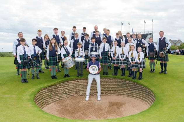 BALMEDIE, SCOTLAND - AUG 23: Scott Jamieson (SCO) holds the Nexo Trophy with the Robert Gordon Academy Pipe band after Round 4 at the 2026 Nexo Championship at the Trump International Golf Links, Balmedie on August 23, 2026 in Aberdeenshire, Scotland The 2026 Nexo Championship