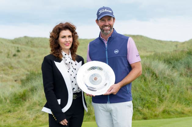 BALMEDIE, SCOTLAND - AUG 23: Scott Jamieson (SCO) receives the Nexo Trophy from Sarah Malone Head of the Trump International after Round 4 at the 2026 Nexo Championship at the Trump International Golf Links, Balmedie on August 23, 2026 in Aberdeenshire, Scotland The 2026 Nexo Championship