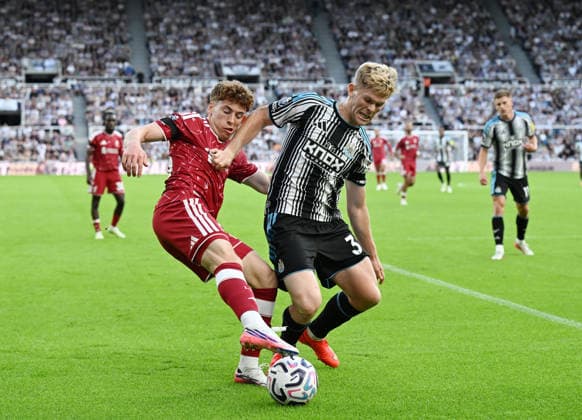 Newcastle Upon Tyne, England, 23rd August 2026. Victor Munoz of Liverpool (l) challenged by Lewis Hall of Newcastle United (r) during the Newcastle United vs Liverpool Premier League match at St. James Park, Newcastle Upon Tyne. Picture credit should read: Anna Gowthorpe Sportimage EDITORIAL USE ONLY. No use with unauthorised audio, video, data, fixture lists, club league logos or live services. Online in-match use limited to 120 images, no video emulation. No use in betting, games or single club league player publications. SPI_048_AG_Newcastle_Liverpool SPI-4932-0045