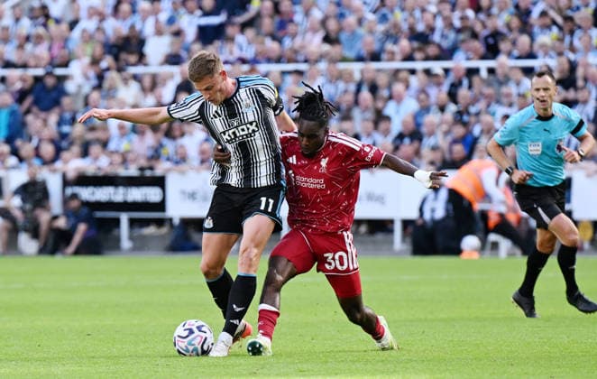 Newcastle Upon Tyne, England, 23rd August 2026. Harvey Barnes of Newcastle United (l) challenged by Jeremie Frimpong of Liverpool (r) during the Newcastle United vs Liverpool Premier League match at St. James Park, Newcastle Upon Tyne. Picture credit should read: Anna Gowthorpe Sportimage EDITORIAL USE ONLY. No use with unauthorised audio, video, data, fixture lists, club league logos or live services. Online in-match use limited to 120 images, no video emulation. No use in betting, games or single club league player publications. SPI_046_AG_Newcastle_Liverpool SPI-4932-0046