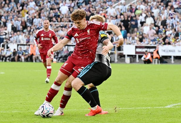 Newcastle Upon Tyne, England, 23rd August 2026. Lewis Hall of Newcastle United tackles Victor Munoz of Liverpool who goes down in the area to earn a penalty in extra time during the Newcastle United vs Liverpool Premier League match at St. James Park, Newcastle Upon Tyne. Picture credit should read: Anna Gowthorpe Sportimage EDITORIAL USE ONLY. No use with unauthorised audio, video, data, fixture lists, club league logos or live services. Online in-match use limited to 120 images, no video emulation. No use in betting, games or single club league player publications. SPI_067_AG_Newcastle_Liverpool SPI-4932-0065