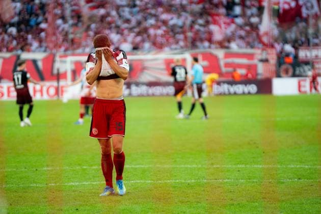 Fortuna Düsseldorf v SC Freiburg - DFB-Pokal First Round A Fortuna Dusseldorf player reacts dejectedly after the final whistle following his side s defeat against SC Freiburg in the DFB-Pokal first round at Merkur Spiel-Arena in Dusseldorf, Germany, August 23, 2026. Dusseldorf Merkur Spiel-Arena North Rhine-Westphalia Germany Copyright: xTaiseixIwamotox