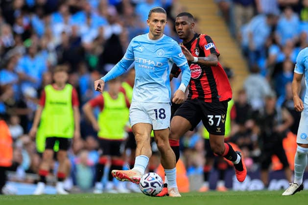 Manchester City v Bournemouth, Premier League Jack Grealish (18) of Manchester City passes the ball under pressure from Rayan (37) of Bournemouth during the Premier League match between Manchester City and Bournemouth at the Etihad Stadium, Manchester, UK on 23 August 2026. Manchester Etihad Stadium Manchester UK Editorial use only DataCo restrictions apply See www.football-dataco.com , Copyright: xConorxMolloyx PSI-24721-0179
