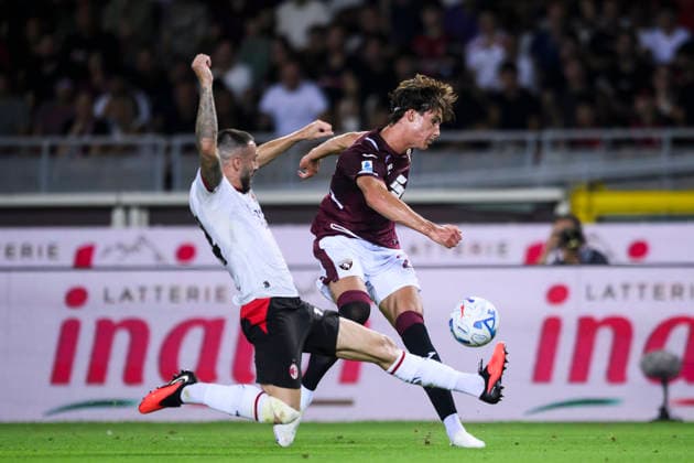 Torino FC v AC Milan - Serie A Cesare Casadei of Torino FC is tackled by Mario Gila of AC Milan during the Serie A football match between Torino FC and AC Milan. Turin Italy Copyright: xNicolòxCampox