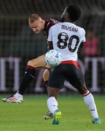 Torino v AC Milan - Serie A - Stadio Grande Torino Turin, Italy, 23rd August 2026. Pietro Comuzzo of Torino FC clears from Yunus Musah of AC Milan during the Torino vs AC Milan Serie A match at Stadio Grande Torino, Turin. Picture credit should read: Jonathan Moscrop Turin Stadio Olimpico Grande Torino Italy
