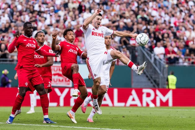 WUERZBURG, GERMANY - AUGUST 24: Luka Lochoshvili (1. FC Koeln, 24) controls the ball against Liam Omore (Wuerzburger Kickers, 17) during the 1st round DFB Pokal match between Wuerzburger Kickers vs. 1. FC Koeln at AKON ARENA on August 24, 2026 in Wuerzburg, Germany. DFB REGULATIONS PROHIBIT ANY USE OF PHOTOGRAPHS AS IMAGE SEQUENCES AND OR QUASI-VIDEO. Bavaria Germany Copyright: xSteffiexWunderlx
