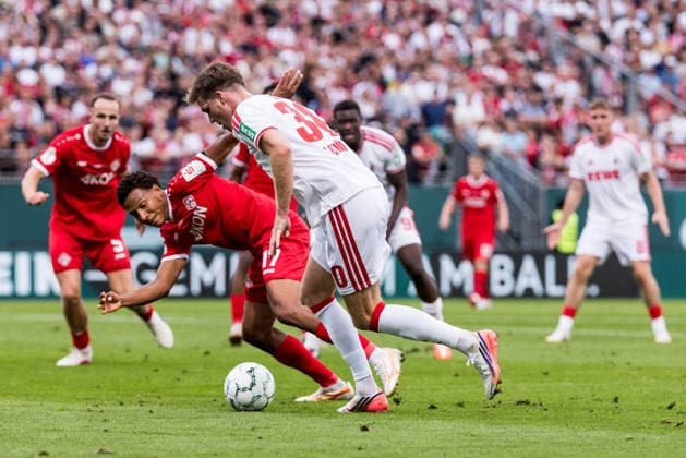 WUERZBURG, GERMANY - AUGUST 24: Marius Buelter (Bülter, Bulter, 1. FC Koeln, 30) controls the ball against Liam Omore (Wuerzburger Kickers, 17) during the 1st round DFB Pokal match between Wuerzburger Kickers vs. 1. FC Koeln at AKON ARENA on August 24, 2026 in Wuerzburg, Germany. DFB REGULATIONS PROHIBIT ANY USE OF PHOTOGRAPHS AS IMAGE SEQUENCES AND OR QUASI-VIDEO. Bavaria Germany Copyright: xSteffiexWunderlx
