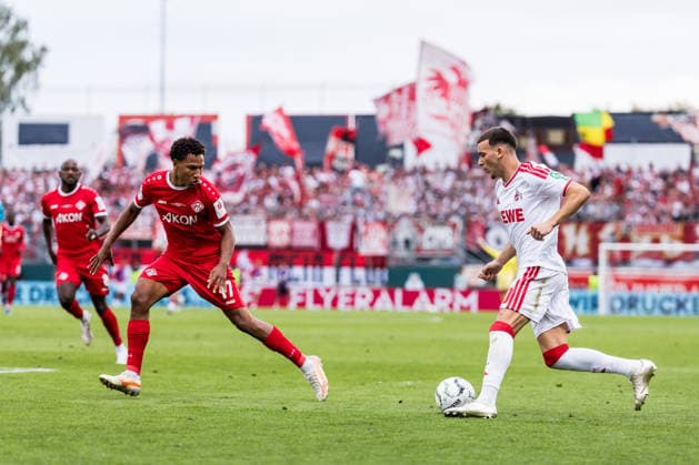 WUERZBURG, GERMANY - AUGUST 24: Said El Mala (1. FC Koeln, 10) controls the ball against Liam Omore (Wuerzburger Kickers, 17) during the 1st round DFB Pokal match between Wuerzburger Kickers vs. 1. FC Koeln at AKON ARENA on August 24, 2026 in Wuerzburg, Germany. DFB REGULATIONS PROHIBIT ANY USE OF PHOTOGRAPHS AS IMAGE SEQUENCES AND OR QUASI-VIDEO. Bavaria Germany Copyright: xSteffiexWunderlx