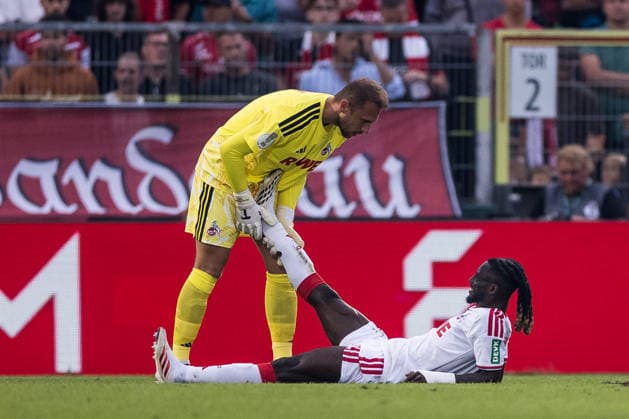 WUERZBURG, GERMANY - AUGUST 24: Marvin Schwaebe (Schwäbe, Schwabe, 1. FC Koeln, 1) helping Gideon Mensah (1. FC Koeln, 14) during the 1st round DFB Pokal match between Wuerzburger Kickers vs. 1. FC Koeln at AKON ARENA on August 24, 2026 in Wuerzburg, Germany. DFB REGULATIONS PROHIBIT ANY USE OF PHOTOGRAPHS AS IMAGE SEQUENCES AND OR QUASI-VIDEO. Bavaria Germany Copyright: xSteffiexWunderlx