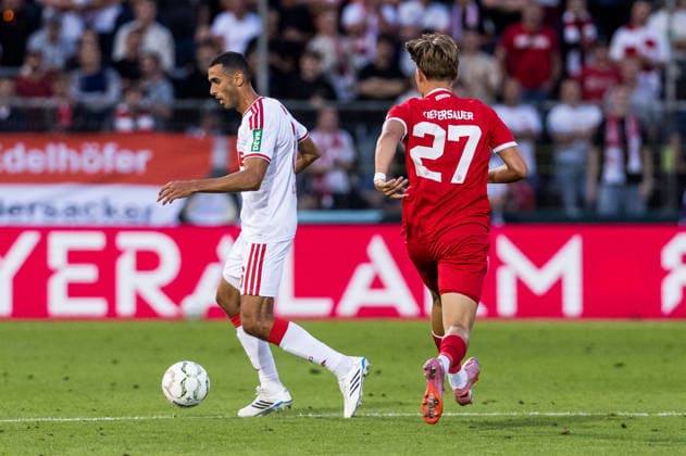 WUERZBURG, GERMANY - AUGUST 24: Ellyes Skhiri (1. FC Koeln, 6) controls the ball against Xaver Kiefersauer (Wuerzburger Kickers, 27) during the 1st round DFB Pokal match between Wuerzburger Kickers vs. 1. FC Koeln at AKON ARENA on August 24, 2026 in Wuerzburg, Germany. DFB REGULATIONS PROHIBIT ANY USE OF PHOTOGRAPHS AS IMAGE SEQUENCES AND OR QUASI-VIDEO. Bavaria Germany Copyright: xSteffiexWunderlx