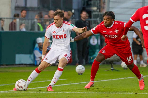 Im Bild: v.li. Paul Okon-Engstler (1. FC Koeln, 23) am Ball gegen Franck Evina (FC Wuerzburger Kickers, 18) 24.08.2026, FC Wuerzburger Kickers - 1. FC Koeln, DFB-Pokal, 1. Runde, Deutschland, Wuerzburg, AKON-Arena, DFL REGULATIONS PROHIBIT ANY USE OF PHOTOGRAPHS AS IMAGE SEQUENCES AND OR QUASI-VIDEO. *** Pictured from left: Paul Okon Engstler (1. FC Köln), No. 23, with the ball against Franck Evina (FC Würzburger Kickers), No. 18, August 24, 2026, FC Würzburg Kickers vs. 1. FC Köln, DFB Cup, First Round, Germany, Würzburg, AKON Arena, DFL regulations prohibit any use of photographs as image sequences and or quasi-video Copyright: HMBxMedia xJulienxBecker
