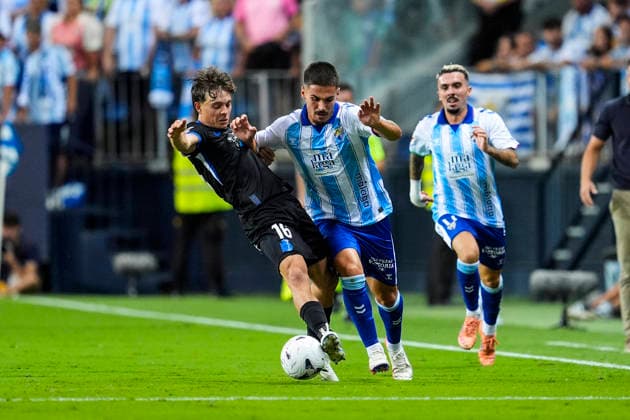 August 24, 2026, Malaga, Malaga, Spain: Lorenzo Amatucci of RC Deportivo and Chupe of Malaga CF in action during the Spanish league, LaLiga EA Sports, football match played between Malaga CF and RC Deportivo at La Rosaleda stadium on August 24, 2026, in Malaga, Spain. Malaga Spain - ZUMAa181 20260824_zaa_a181_140 Copyright: xJoaquinxCorcherox