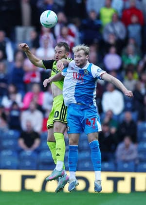 Blackburn, England, 25th August 2026. Rhys Norrington Davies of Sheffield United challenges Lucas Houghton of Blackburn Rovers during the Blackburn Rovers vs Sheffield United Carabao Cup Second Round match at Ewood Park, Blackburn. Picture credit should read: Simon Bellis Sportimage EDITORIAL USE ONLY. No use with unauthorised audio, video, data, fixture lists, club league logos or live services. Online in-match use limited to 120 images, no video emulation. No use in betting, games or single club league player publications. SPI_007_SB_BBurn_Sheffield_Unnited SPI-4935-0007