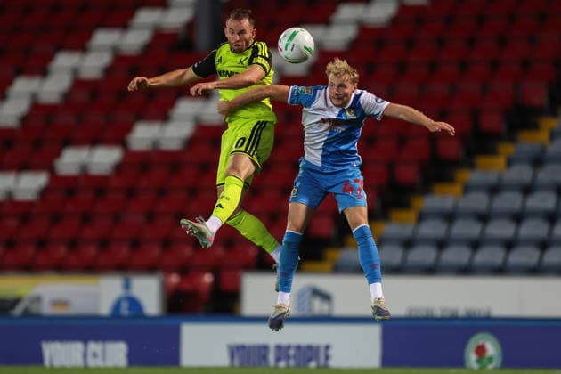 25th August 2026; Ewood Park, Blackburn, England; Carabao Cup Football, Blackburn Rovers versus Sheffield United; Lucas Houghton of Blackburn Rovers and Rhys Norrington-Davies of Sheffield United challenge for the ball in the air AidanxHunter