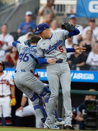 First baseman Freddie Freeman 5 of the Los Angeles Dodgers collides with catcher Hunter Feduccia 46 catching a pop up in the first inning against the Atlanta Braves at Truist Park on Tuesday, August 25, 2026 in Atlanta, Georgia.  ATL20260825104 MikexZarrilli