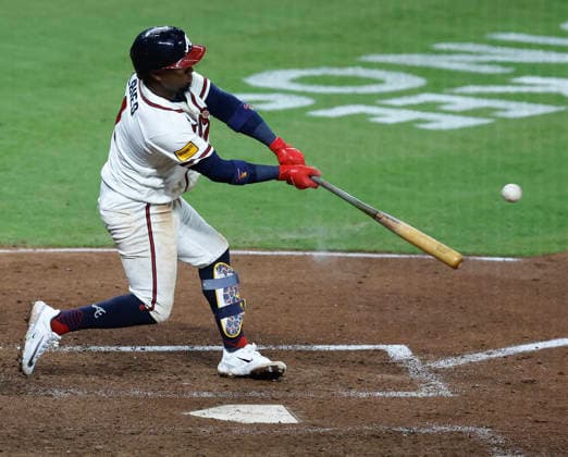Second baseman Ozzie Albies 1 of the Atlanta Braves hits a go-ahead RBI single in the eighth inning against the Los Angeles Dodgers att Truist Park on Tuesday, August 25, 2026 in Atlanta, Georgia.  ATL20260825107 MikexZarrilli