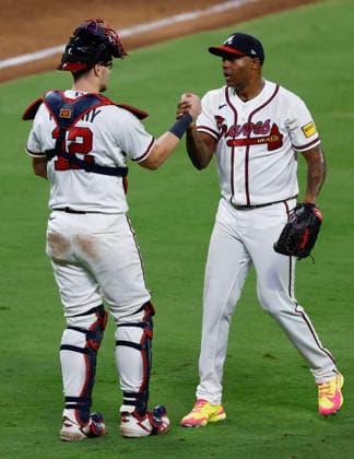 Pitcher Raisel Iglesias 26 of the Atlanta Braves (right) shakes hands with catcher Sean Murphy 12 after the last out against the Los Angeles Dodgers at Truist Park on Tuesday, August 25, 2026 in Atlanta, Georgia.  ATL20260825110 MikexZarrilli