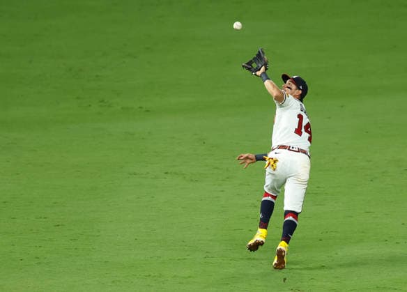 Shortstop Mauricio Dubon 14 of the Atlanta Braves back pedals to make a catch in the sixth inning against the Los Angeles Dodgers at Truist Park on Tuesday, August 25, 2026 in Atlanta, Georgia.  ATL20260825215 MikexZarrilli