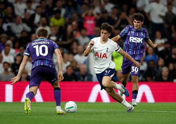 Mikey Moore of Tottenham Hotspur takes on Rob Apter (30) and Greg Docherty (10) of Charlton Athletic Tottenham Hotspur v Charlton Athletic, EFL Carabao Cup, Second Round, Football, Tottenham Hotspur Stadium, London, UK - 26 Aug 2026London Tottenham Hotspur Stadium United Kingdom EDITORIAL USE ONLY No use with unauthorised audio, video, data, fixture lists, club league logos or live services. Online in-match use limited to 120 images, no video emulation. No use in betting, games or single club league player publications. Copyright: xMattxImpey Shutterstockx 17115050at