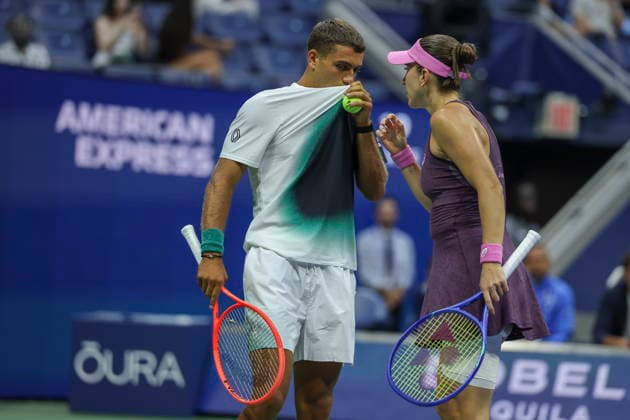 2026 US Open Mixed Doubles Championship semifinals Belinda Bencic (R) of Switzerland and Flavio Cobolli (L) of Italy cover their mouths while they talk strategy during the semifinal round of the Mixed Doubles Championship against Elina Svitolina of Ukraine and Gael Monfils of France at the Arthur Ashe Stadium in the USTA Billie Jean King National Tennis Center in Flushing Meadows, New York, USA, 26 August 2026. FLUSHING MEADOWS NEW YORK UNITED STATES  Copyright: xSARAHxYENESELx