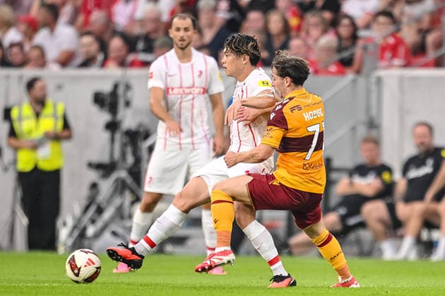 Yuito Suzuki (SC Freiburg) and Joe Hodge (Motherwell FC) battle for the ball during the UEFA Conference League 2026 27 Play Off Round Second Leg match between Club Freiburg and Motherwell at Stadion am Wolfswinkel on August 27, 2026 in Freiburg, Germany. (Photo by Harry Langer DeFodi Images) -