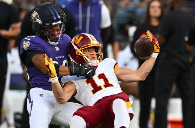 Washington Commanders wide receiver Luke McCaffrey (11) makes a one handed catch in front of Baltimore Ravens safety Keondre Jackson (39) for a first down during the second quarter of a preseason game at M&T Bank Stadium in Baltimore, Maryland, on Friday, August 28, 2026.  BAL20260828110 DAVIDxTULIS