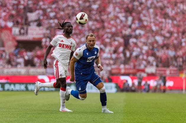 KOELN, GERMANY - AUGUST 29: Gideon Mensah (1. FC Koeln, 14) controls the ball against Alessandro Vogt (TSG 1899 Hoffenheim, 24) during the Bundesliga match between 1. FC Koeln vs. TSG 1899 Hoffenheim at Rheinenergie-Stadion on matchday 1 of the 1. Bundesliga on August 29, 2026 in Koeln, Germany. DFL REGULATIONS PROHIBIT ANY USE OF PHOTOGRAPHS AS IMAGE SEQUENCES AND OR QUASI-VIDEO. North Rhine Westphalia Germany Copyright: xSteffiexWunderlx