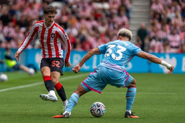 30th August 2026; Stadium of Light, Sunderland, England; Premier League Football, Sunderland versus Fulham; Trai Hume of Sunderland AFC passes the ball through Antonee Robinson of Fulham FCs legs PeterxNorth