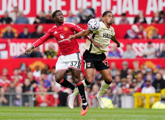 Manchester, England, 30th August 2026. Kobbie Mainoo of Manchester United, ManU challenges Emersonn of Ipswich Town during the Manchester United vs Ipswich Town Premier League match at Old Trafford, Manchester. Picture credit should read: Andrew Yates Sportimage EDITORIAL USE ONLY. No use with unauthorised audio, video, data, fixture lists, club league logos or live services. Online in-match use limited to 120 images, no video emulation. No use in betting, games or single club league player publications. SPI_034_AY_Man_Utd_Ipswich SPI-4945-0034
