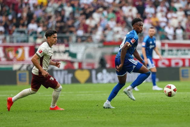 Junior Adamu (FC Schalke 04, 20) mit Ball mit Fabian Rieder (FC Augsburg, 32), GER, FC Augsburg vs. FC Schalke 04, Fussball, Bundesliga, 1. Spieltag, Saison 2026 2027, 30.08.2026, DFL DFB REGULATIONS PROHIBIT ANY USE OF PHOTOGRAPHS as IMAGE SEQUENCES and or QUASI-VIDEO, GER, FC Augsburg vs. FC Schalke 04, Fussball, Bundesliga, 1. Spieltag, Saison 2026 2027, 30.08.2026 Augsburg *** Junior Adamu, FC Schalke 04, 20, with the ball, alongside Fabian Rieder, FC Augsburg, 32, GER, FC Augsburg vs. FC Schalke 04, Soccer, Bundesliga, Matchday 1, 2026–2027 Season, August 30, 2026, DFL and DFB regulations prohibit any use of photographs as image sequences and or quasi-video, GER, FC Augsburg vs. FC Schalke 04, soccer, Bundesliga, Matchday 1, 2026–2027 Season, August 30, 2026, Augsburg Copyright: xEibner-Pressefoto JennixMaulx EP_JML