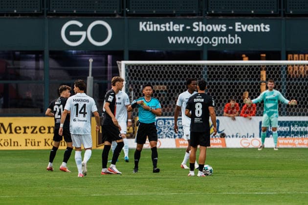 Deutschland: Fußball 3. Liga Männer 2026 - 2027, 3. Spieltag - FC Viktoria Köln vs SC Preußen Münster (Köln): Schiedsrichter Ryo Tanimoto (Japan, FIFA-Referee) zeigt gelbe Karte, Foul, Verwarnung gegen Lucas Zeller (SC Preußen Münster, 5) Copyright: xThiemoxRudolphx