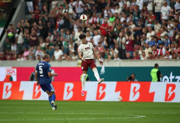 Fussball, Herren, Saison 2026 2027, FC Augsburg - FC Schalke 04, Bundesliga, WWK Arena Rodrigo Ribeiro (FC Augsburg) springt zu einem Kopfball in die Höhe, Sprung, Abheben DFL DFB regulations prohibit any use of photographs as image sequences and or quasi-video *** Soccer, Men s, 2026–2027 Season, FC Augsburg vs. FC Schalke 04, Bundesliga, WWK Arena: Rodrigo Ribeiro of FC Augsburg leaps for a header; jump, takeoff. DFL and DFB regulations prohibit any use of photographs as image sequences and or quasi-video.