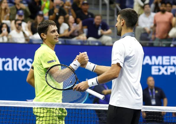 Novak Djokovic of Serbia meets Mariano Navone of Argentina at net after their first round match in Arthur Ashe Stadium at the 2026 US Open Tennis Championship at the USTA Billie Jean King National Tennis Center in New York City on Sunday, August 30, 2026. Navone defeated Djokovic in 5 sets.  NYP20260830150 JOHNxANGELILLO