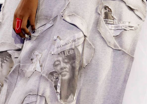 Naomi Osaka of Japan wears a dress design with newspaper clippings regarding herself when before her first round match against Anastasia Zakharova in Arthur Ashe Stadium at the 2026 US Open Tennis Championship at the USTA Billie Jean King National Tennis Center in New York City on Monday, August 31, 2026.  NYP20260831149 JOHNxANGELILLO