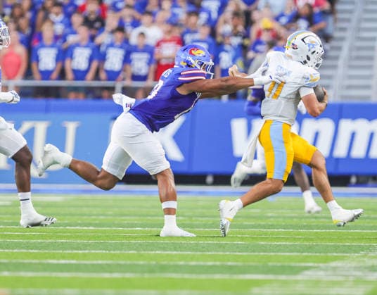 Sep 4, 2026: Kansas Jayhawks linebacker Quincy Davis (13) pushes Long Island Sharks quarterback Luca Stanzani (11) out of bounds in Lawrence, KS, USA; at Memorial Stadium. Mandatory Credit: -Cal Media NCAA, College League, USA Football 2026: LIU Vs Kansas SEP 04  - ZUMAc04_ 20260904_zma_c04_063 Copyright: xRomanxPunox