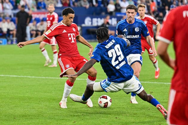 GELSENKIRCHEN, GERMANY; 05. SEPTEMBER: tackle between Jamal MUSIALA (FC Bayern Munich 10) and Eric Junior DINA EBIMBE (FC Schalke 29) during the Bundesliga Match between FC Schalke 04 vs. FC Bayern Munich at Matchday 2 at Veltins Arena DFL REGULATIONS PROHIBIT ANY USE OF PHOTOGRAPHS AS IMAGE SEQUENCES AND OR QUASI-VIDEO Copyright: xBEAUTIFULxSPORTS Goldbergx