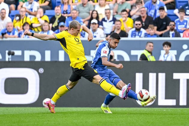 Julian Ryerson (Borussia Dortmund) und Adam Daghim (TSG 1899 Hoffenheim) im Zweikampf waehrend des spiels der 1. Bundesliga zwischen TSG Hoffenheim und Borussia Dortmund, SNP Arena am 05. September 2026 in Sinsheim, Deutschland. (Foto von Harry Langer DeFodi Images) +++ Julian Ryerson (Borussia Dortmund) und Adam Daghim (TSG 1899 Hoffenheim) battle for the ball during the Bundesliga match between TSG Hoffenheim and Borussia Dortmund at SNP Arena on September 5, 2026 in Sinsheim, Germany. (Photo by Harry Langer DeFodi Images) DFB DFL REGULATIONS PROHIBIT ANY USE OF PHOTOGRAPHS AS IMAGE SEQUENCES AND OR QUASI-VIDEO. (Photo by Harry Langer DeFodi Images) DFB DFL REGULATIONS PROHIBIT ANY USE OF PHOTOGRAPHS AS IMAGE SEQUENCES AND OR QUASI-VIDEO. - *** Julian Ryerson of Borussia Dortmund and Adam Daghim of TSG 1899 Hoffenheim go head-to-head during the Bundesliga 1 match between TSG Hoffenheim and Borussia Dortmund, SNP Arena on September 5, 2026, in Sinsheim, Germany. Photo by Harry Langer, DeFodi Images. Julian Ryerson of Borussia Dortmund and Adam Daghim of TSG 1899 Hoffenheim battle for the ball during the Bundesliga match between TSG Hoffenheim and Borussia Dortmund at SNP Arena on September 5, 2026 in Sinsheim, Germany. Photo by Harry Langer, DeFodi Images. DFB and DFL regulations prohibit any use of photographs as image sequences and or quasi-video. Photo by Harry Langer, DeFodi Images. DFB and DFL regulations prohibit any use of photographs as imSEQUENCES AND OR QUASI-VIDEO